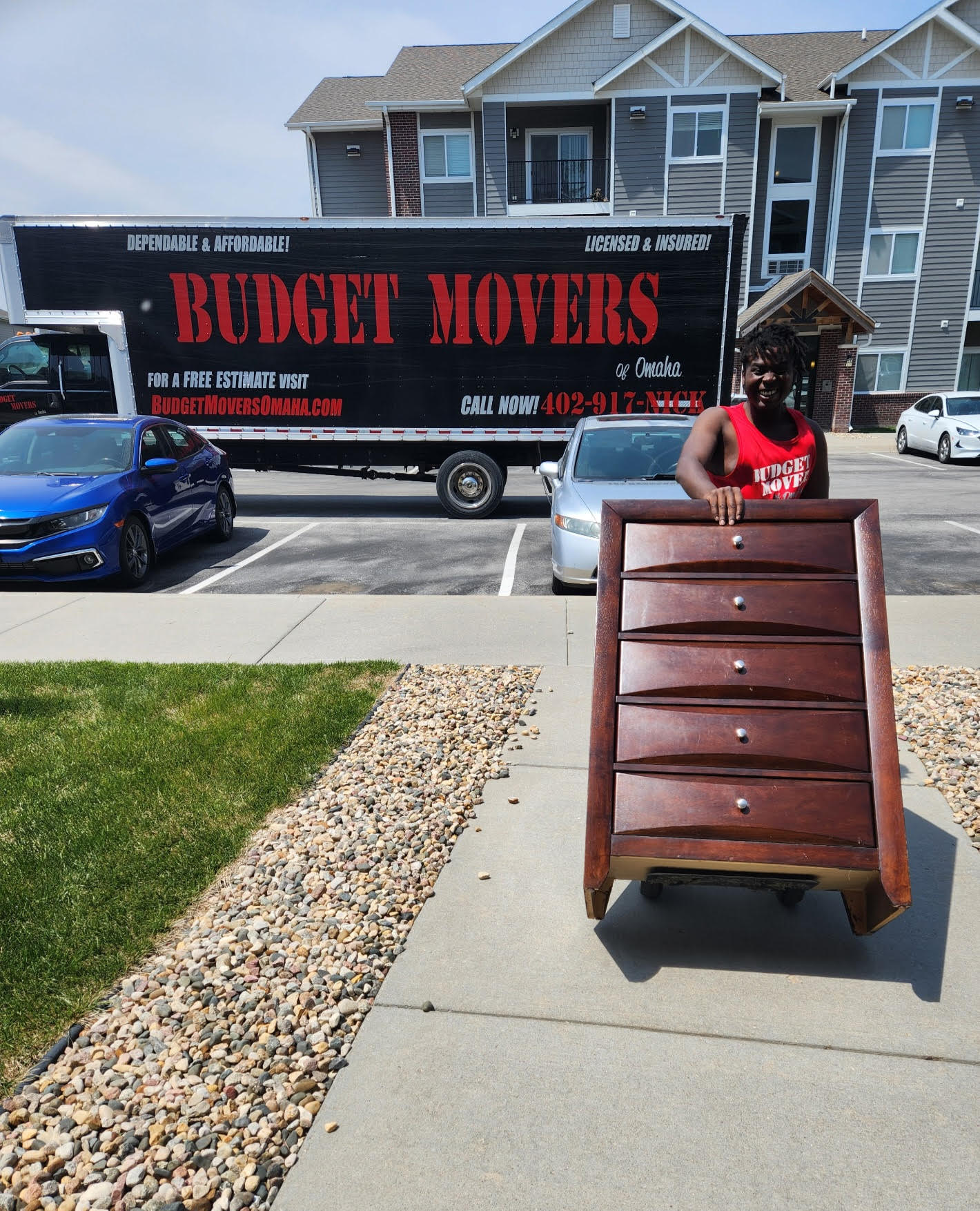 Budget Movers truck and crew at an Omaha apartment complex
