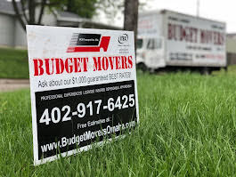 Budget Movers yard sign with the $1,000 best rate guarantee