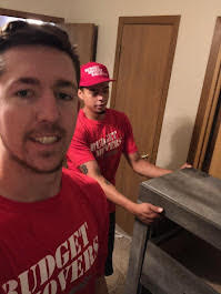 Budget Movers team members on the job in branded red gear