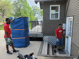 Budget Movers team carefully wrapping and protecting furniture
