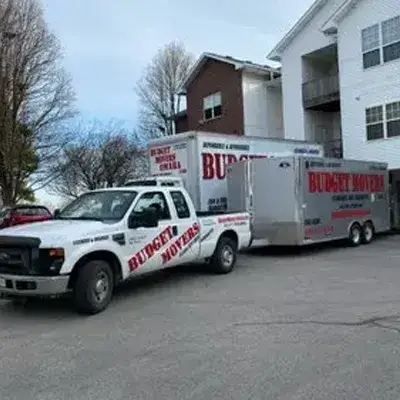 Budget Movers pickup with enclosed trailer at an apartment complex